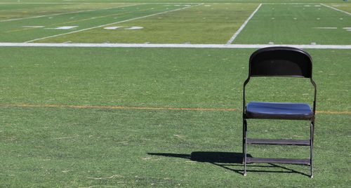 Empty chair on green grass
