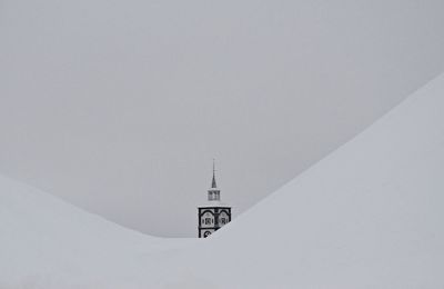 Information sign on snow against clear sky