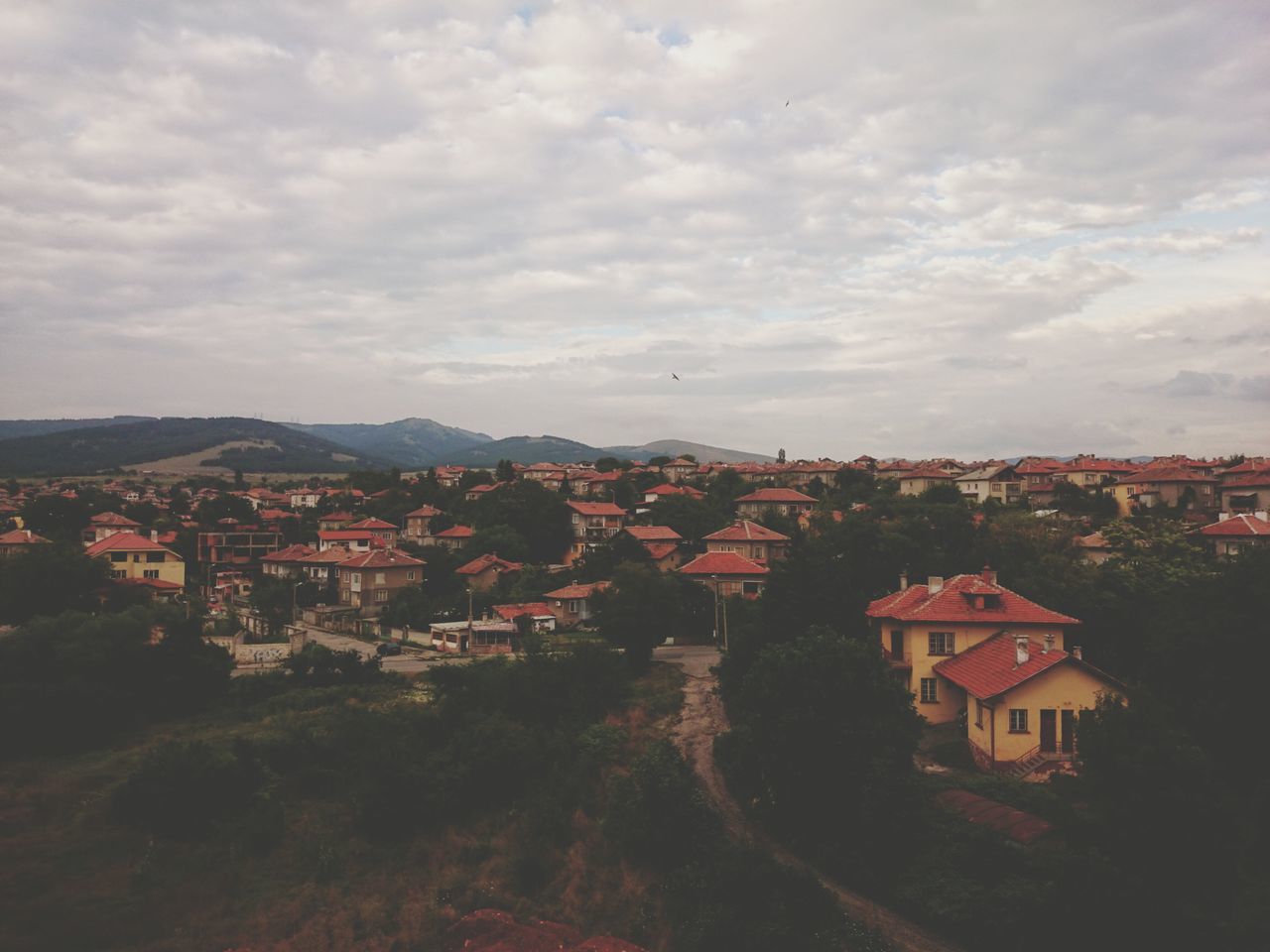 building exterior, architecture, built structure, sky, house, residential structure, residential district, cloud - sky, residential building, town, townscape, high angle view, cityscape, cloudy, crowded, city, tree, cloud, community, roof