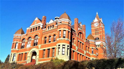 Low angle view of buildings against blue sky