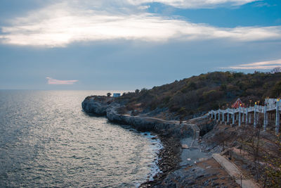 Scenic view of sea by bridge against sky