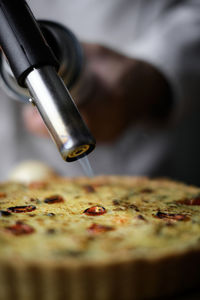 Close-up of hand holding pizza