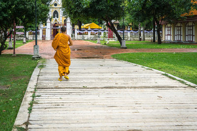 Rear view of a woman walking on cross