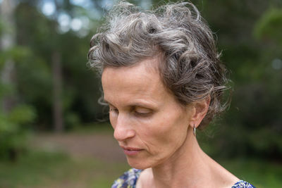 Close-up of thoughtful mature woman looking down