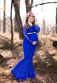Young woman standing in a forest
