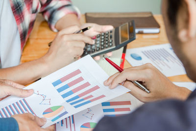 Group businessman  using calculator calculating bonus to employees to increase productivity.