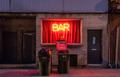 Red light neon painting on building at night