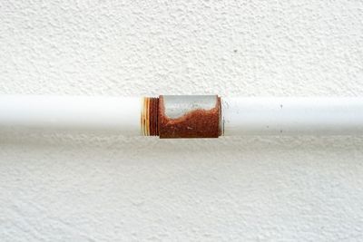 Close-up of cigarette on wall