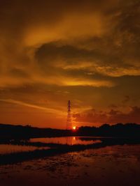 Scenic view of silhouette beach against sky during sunset