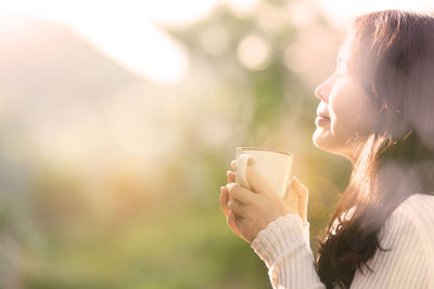 Close-up of woman holding coffee cup