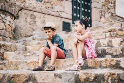Cute sibling sitting on staircase