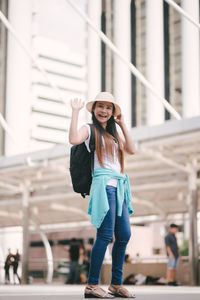 Tourist with luggage standing on steps in city