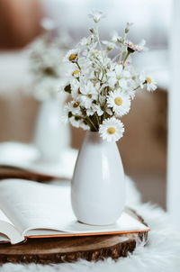 Close-up of white flower vase on table