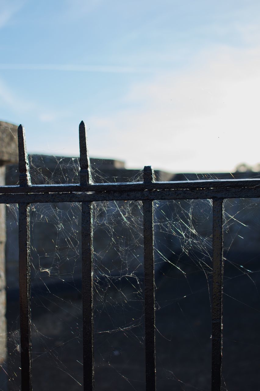 CLOSE-UP OF FENCE AGAINST SKY