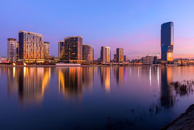 Reflection of illuminated buildings in water