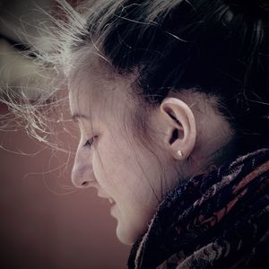 Close-up portrait of a young woman looking away