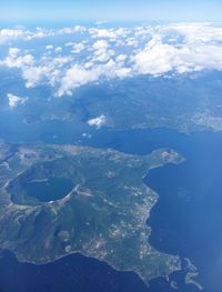 Aerial view of sea and mountains against sky