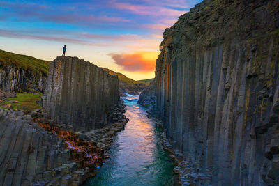 Panoramic view of rock formations against sky during sunset