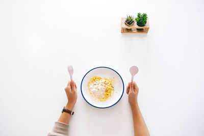 Directly above shot of woman holding coffee cup