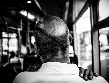Rear view of man sitting in bus