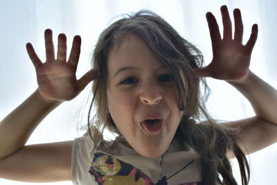 Portrait of happy girl with arms raised