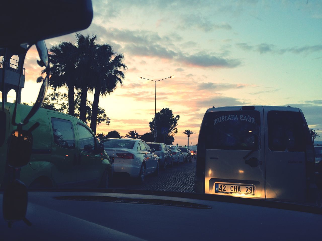 transportation, sky, sunset, land vehicle, car, mode of transport, tree, cloud - sky, silhouette, road, cloud, travel, street, orange color, vehicle interior, nature, cloudy, palm tree, dusk, outdoors