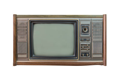 Close-up of vintage television against white background