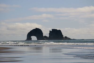 Rock formation off the oregon coast with sea birds.