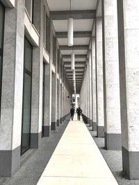 Rear view of woman walking in corridor