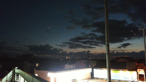 Illuminated cityscape against sky at night