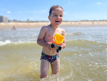 Portrait of young woman swimming in sea