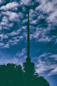 Low angle view of tower against cloudy sky