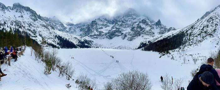 Rear view of man standing on snow covered mountains