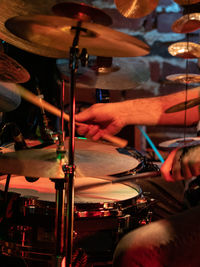 Midsection of man playing drum