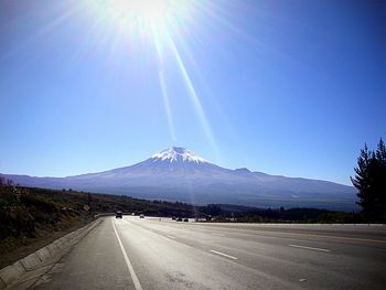 Country road leading towards mountains