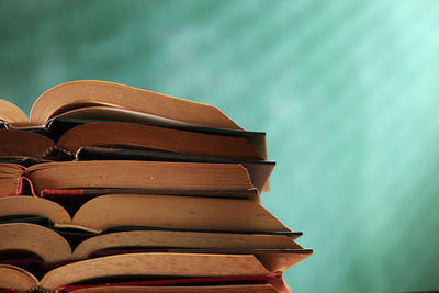 Stack of books on table against wall