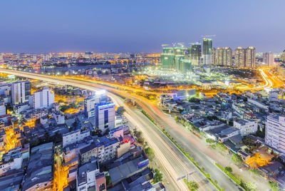 High angle view of illuminated cityscape against sky at night