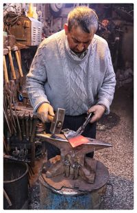 Man working on barbecue grill