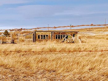 Abandoned built structure on field against sky