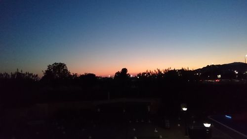 Silhouette trees against sky at sunset