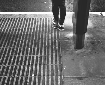 Low section of woman standing on tiled floor