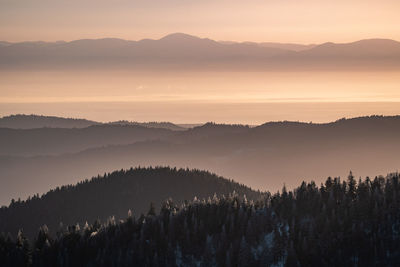 Scenic view of silhouette mountains against sky during sunset