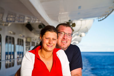 Portrait of smiling mature couple in ship on sea