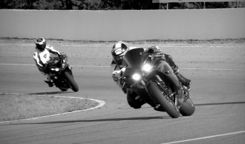 People riding motorcycle on road