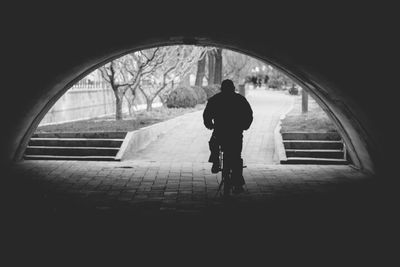 Silhouette of woman walking on railing