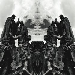 Low angle view of statues against sky