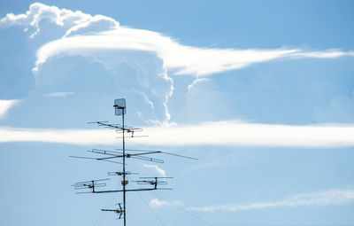 Low angle view of telephone pole against sky