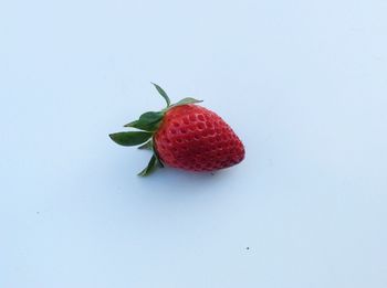 Close-up of strawberry over white background