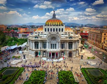 Opera house in mexico city against cloudy sky