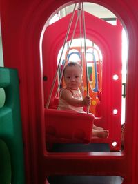 Portrait of cute baby sitting on swing